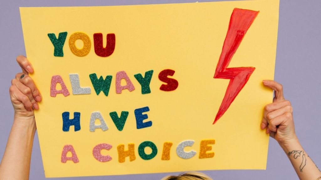 woman holding up a placard that says 'You always have a choice'