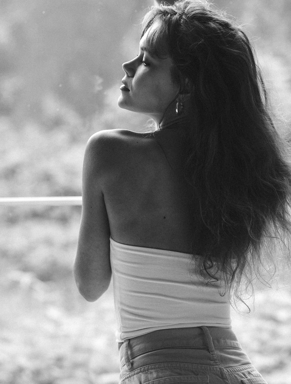grayscale photo of a woman wearing a tube top