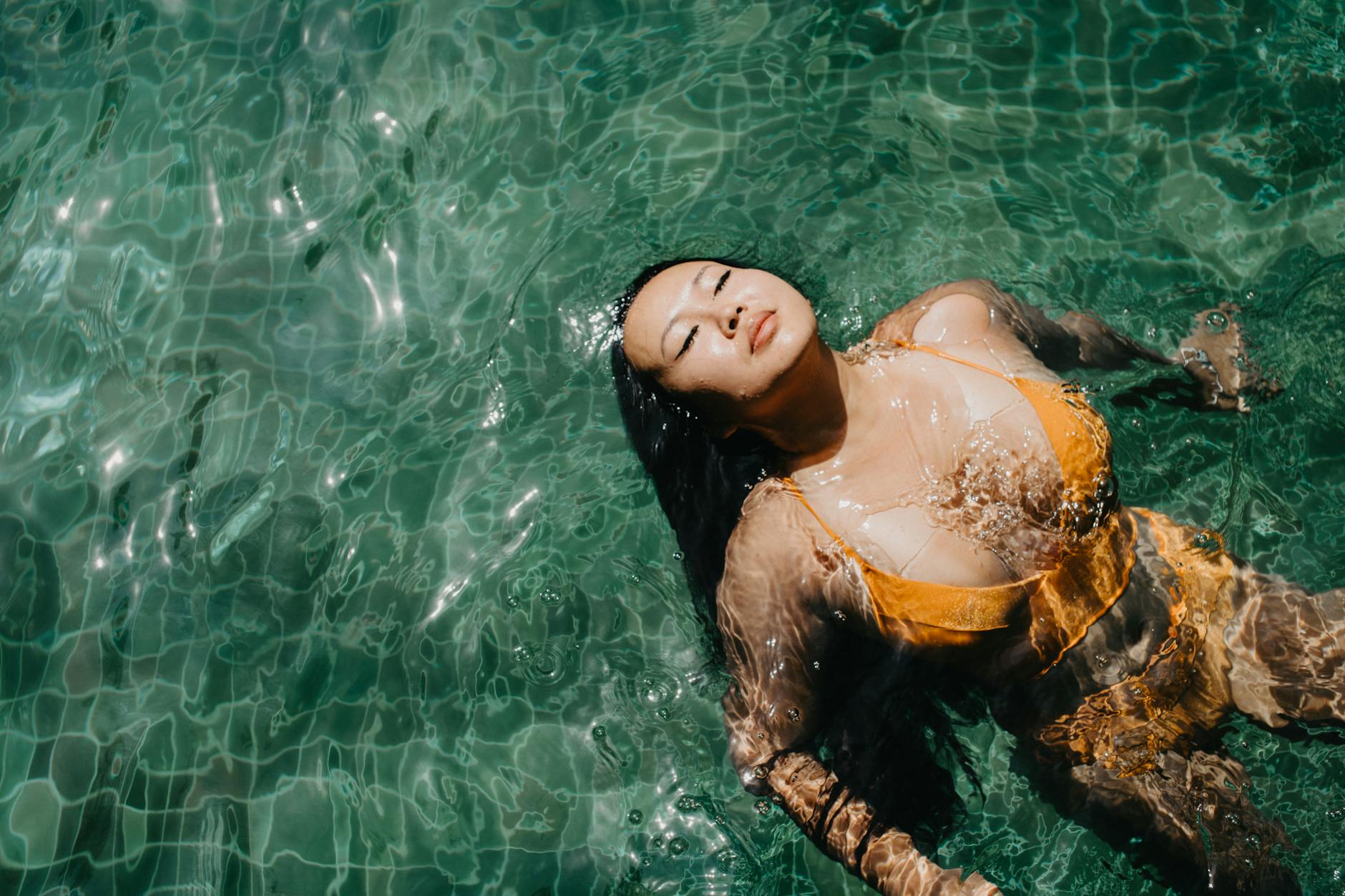 a woman in yellow bikini top